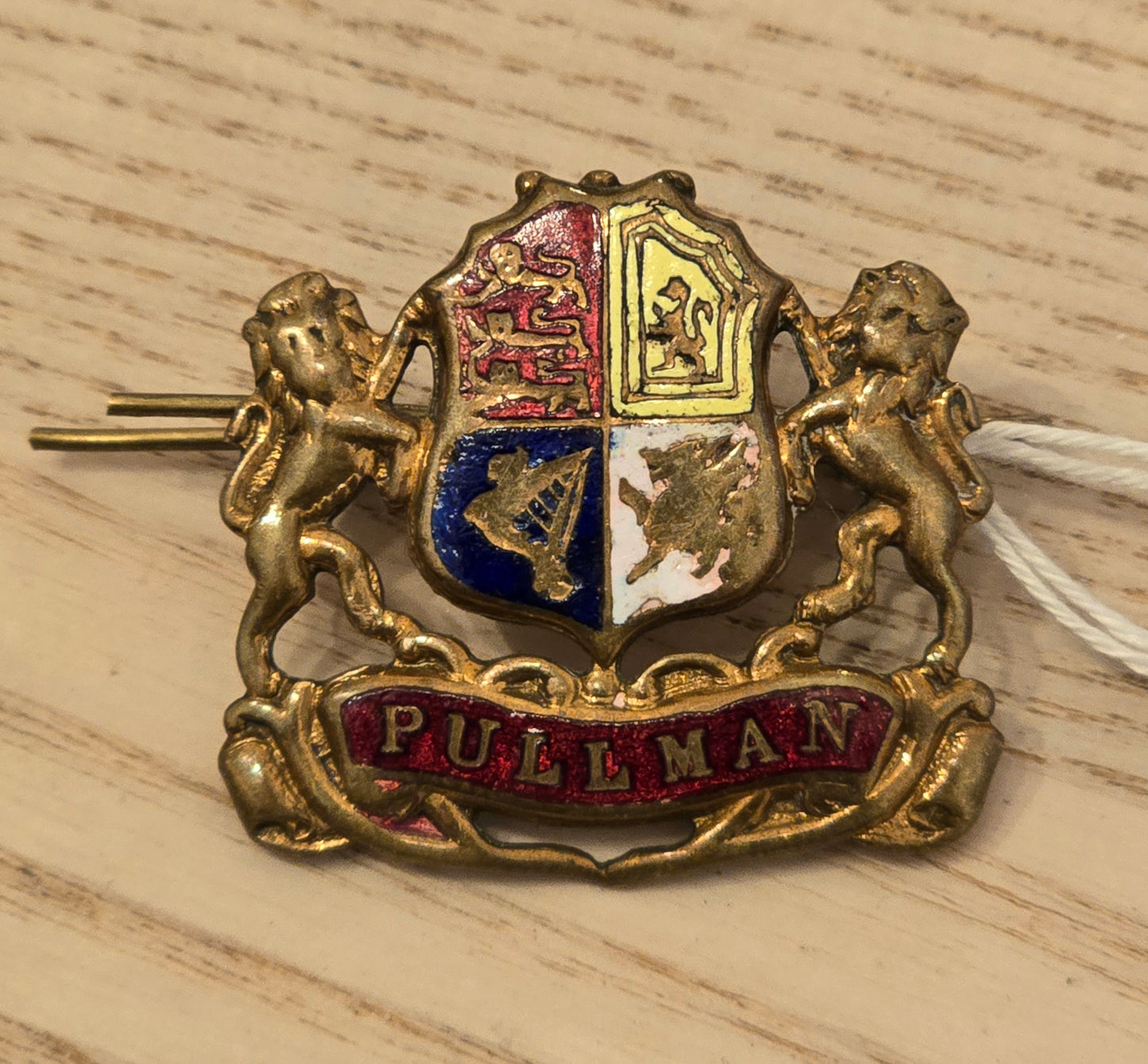 RA 7521 BRASS AND ENAMEL "PULLMAN" LAPEL BADGE.
