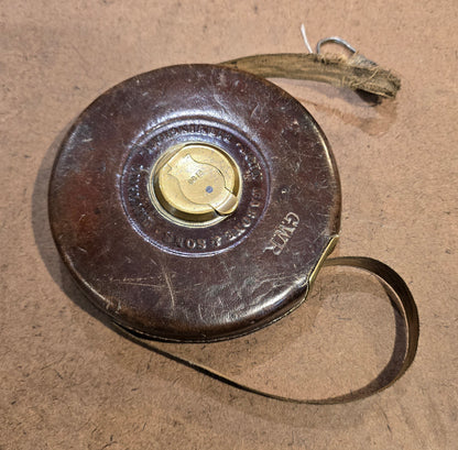 RA 7779  G.W.R. RABONE & SON, BIRMINGHAM 65 FOOT LEATHER CASE TAPE MEASURE.